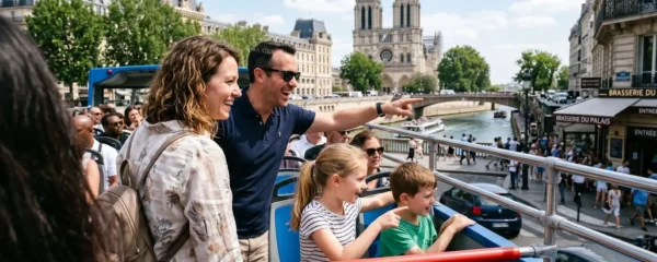 An American family of four sitting on the upper deck of an open-top sightseeing bus, with parents and two children gazing at Parisian landmarks in the distance under bright natural daylight