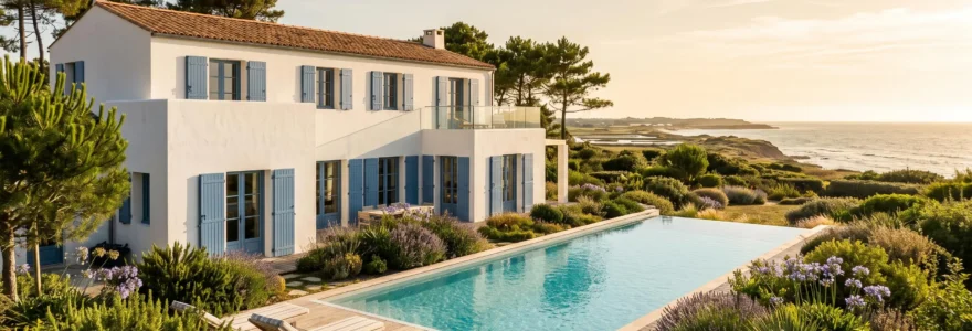 White luxury villa with infinity pool on Île de Ré, featuring traditional blue shutters and terracotta roof, surrounded by coastal garden vegetation under warm natural sunlight